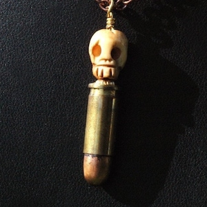 Bone And Bullet --- Hand Carved Bone Skull And Antiqued 25 Caliber Bullet Necklace - Unisex