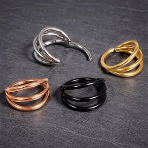 Aro nasal de titanio con triple bisagra para tabique nasal, hélix y aro con segmento hipoalergénico.