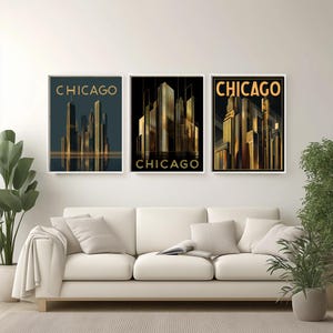 May include: Three framed art prints featuring stylized depictions of the Chicago skyline. Each print has a white border and the word "CHICAGO" in gold lettering. The artwork showcases the city's architecture in shades of gold and dark teal.