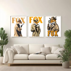 May include: Three framed art prints depicting foxes dressed as detectives. Each fox is wearing a trench coat and hat, holding a magnifying glass. The word "FOX" is printed in orange below each image. The artwork has a vintage, illustrated style.