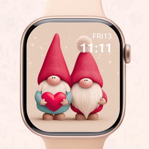 May include: A smartwatch displays a whimsical illustration of two gnomes. One gnome holds a red heart, while the other has a white pom-pom on its red hat. The time is 11:11 on Friday the 13th. The watch has a gold case and a light pink band.