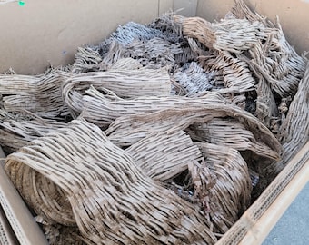 May include: A cardboard box filled with crumpled brown packing paper. The paper is used for protecting fragile items during shipping.