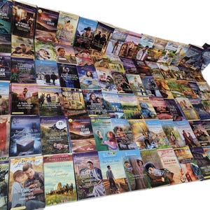 May include: A large collection of paperback books with various titles and covers. The books are arranged in rows and columns, creating a colorful and textured display.