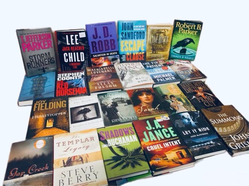 May include: A collection of paperback books with various titles and authors. The books are stacked in a pile, with some of the titles visible. The books are all different colors and sizes.