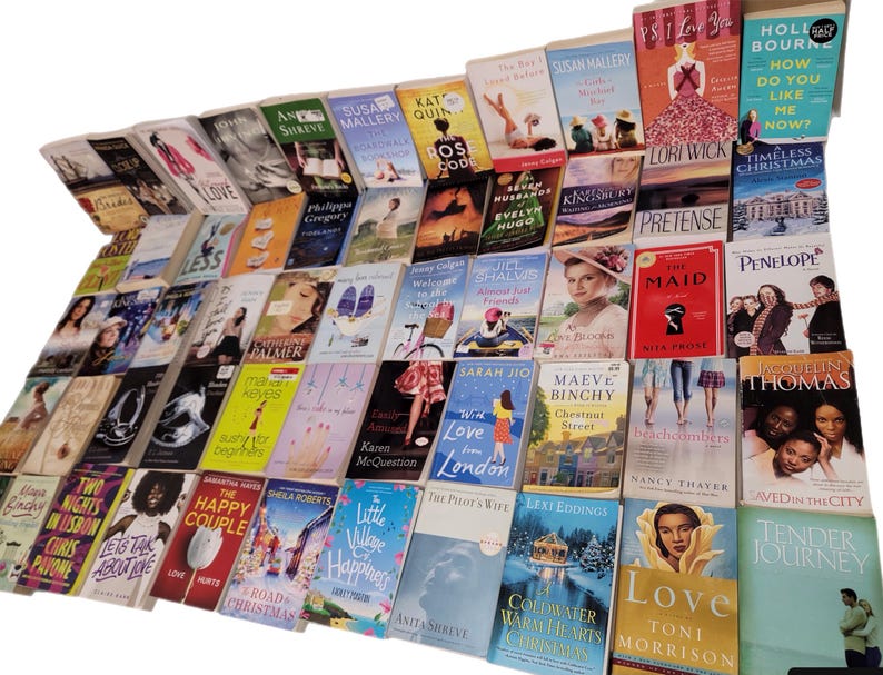 May include: A large collection of paperback books, mostly romance novels, with colorful covers and titles like "The Happy Couple", "Love Less", "Win Love in London", and "Pretense".