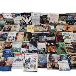 May include: A collection of over 100 hardcover books, mostly about history, with titles like "The Wright Brothers", "1914", "Blood on the Sea", "Lost in Shangri-La", and "The Forgotten 500".