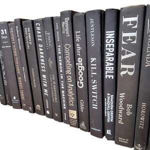 May include: A collection of black and white books stacked vertically. The titles of the books include "Fear", "Inseparable", "Kill Switch", "Life after Google", "Competing on Analytics", "The Demon in the Machine", "Chase Darkness with Me", "The Power of Right Believing", "Culture Warrior", "Trickle Down Tyranny", "31 Days", "Believe", and more.