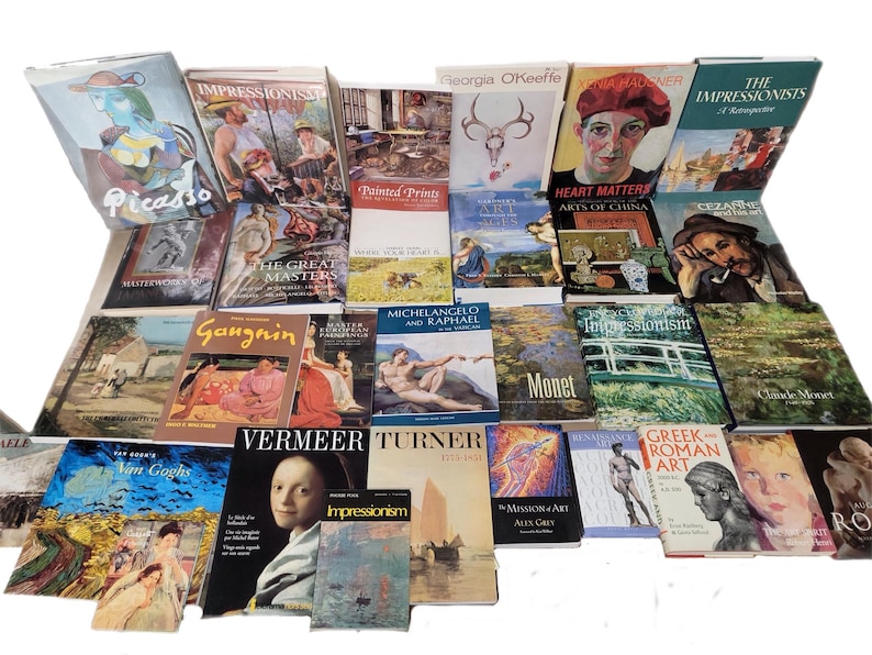 May include: A collection of art books featuring various artists, including Picasso, Monet, Van Gogh, and Cezanne. The books are arranged in a grid pattern and cover a range of art movements and styles.