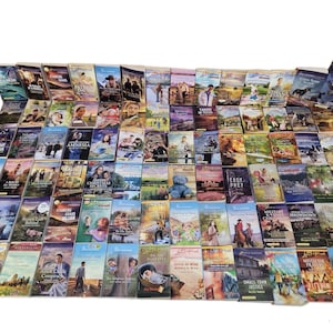 May include: A large collection of paperback books with various titles and covers. The books are arranged in rows and columns, and they are all in good condition.