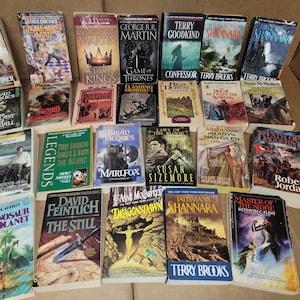 May include: A collection of fantasy and science fiction paperback books, including titles like "The Belmaker", "Game of Thrones", "Confessor", "Shannara", "Legends", "Dragonsdawn", "The Still", and "Master of the Sidhe".