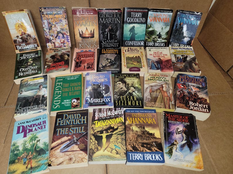 May include: A collection of fantasy and science fiction paperback books, including titles like "The Belmaker", "Game of Thrones", "Confessor", "Shannara", "Legends", "Dragonsdawn", "The Still", and "Master of the Sidhe".