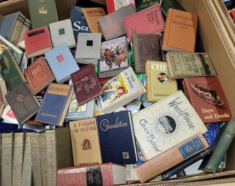 May include: A box filled with a variety of vintage hardcover books. The books have titles such as "Treasure Island", "Strike Him Out", "Days and Deeds", "White House", "Cook Book", "Consolation", "A Figure in Hiding", "Of Anne of Avonlea", "Che", "East of the Sun and West of the Moon", and "The Jane Brinkley Book".