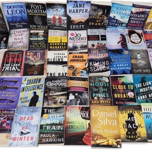 May include: A large collection of paperback books with various titles and authors. The books are arranged in rows and columns, and many of the covers feature colorful illustrations and text.