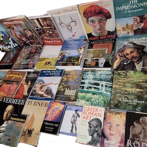 May include: A collection of art books featuring various artists and art movements, including Impressionism, Cezanne, Monet, and Michelangelo. The books are arranged in a pile on a surface.
