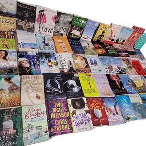 May include: A collection of paperback books with various titles and authors. The books are stacked in a pile, with the spines facing out. The books are mostly romance novels, with some other genres mixed in.