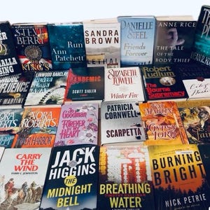 May include: A collection of paperback books stacked in a pile. The books are a mix of genres, including mystery, thriller, romance, and historical fiction. The titles of some of the books include "Valhalla Rising", "The King's Influence", "Friends Forever", "The Tale of the Body Thief", "The Bad Place", "Winter Fire", "The Bourne Supremacy", "Sea Swept", "Forever in My Heart", "The Midnight Bell", "Breathing Water", and "Burning Bright".
