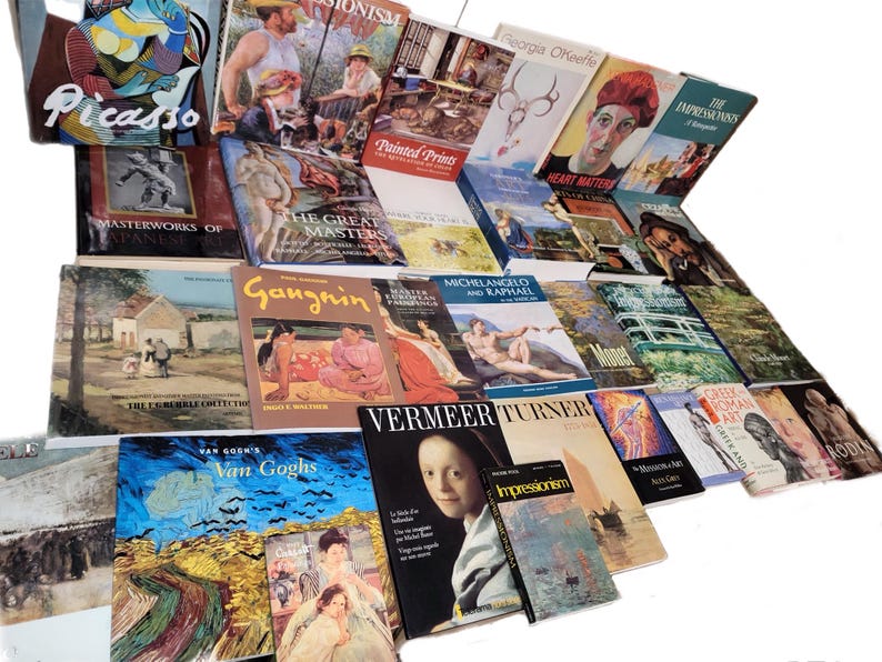 May include: A collection of art books featuring various artists, including Picasso, Monet, Van Gogh, and Turner. The books are arranged in a staggered pattern, with the spines facing outward. The covers of the books are colorful and feature images of famous paintings.