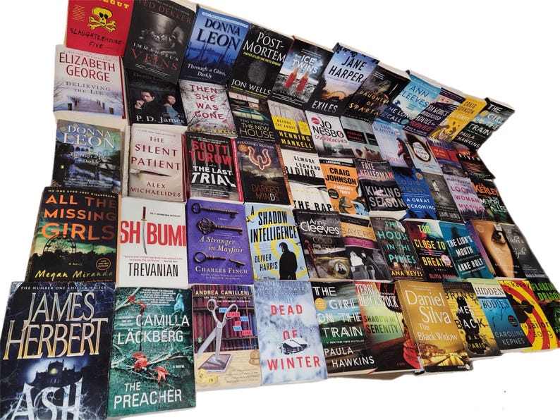 May include: A large collection of paperback books with various titles and authors. The books are stacked in a pile, with the spines facing out. The books are mostly in the mystery and thriller genres.