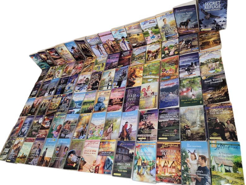 May include: A large collection of paperback books with various titles and authors. The books are arranged in rows and columns, and they are all in good condition. The books are mostly romance novels, with some mystery and thriller titles.