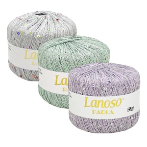 May include: Three balls of sequined yarn in silver, green, and lavender. Each ball is labelled "Lanoso Parla" and weighs 25g. Suitable for knitting and crochet. A craft item.