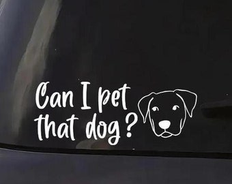 May include: A black car with a white vinyl sticker on the rear window that says "Can I pet that dog?" with a silhouette of a dog's head.