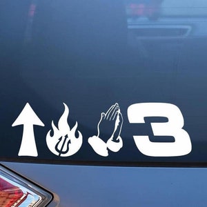 May include: A white vinyl sticker with the words "103" and a flame with a trident inside, a pair of praying hands, and an upward pointing arrow.