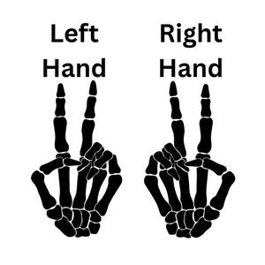 May include: A black graphic illustration of two skeletal hands against a white background. The left hand is labeled Left Hand and the right hand is labeled Right Hand. Both skeletal hands are positioned in a peace sign gesture with fingers.