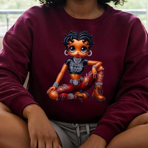 Maroon Betty Boop Sweatshirt Vintage Cartoon Character Classic Animation Design Retro Streetwear Style Pop Culture Icon Cotton Crewneck Collector Item Fashion Statement Comfortable Everyday Wear Trendy Apparel Gift Nostalgic Animation Fan