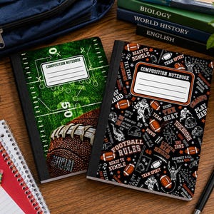 May include: Two composition notebooks with American football themes. One features a green field graphic with a football and the text COMPOSITION NOTEBOOK. The other has a black background with football icons and text including FOOTBALL RULES.