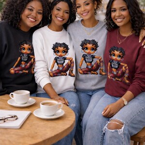 Four people wearing sweatshirts with a Betty Boop cartoon graphic of a woman with the text "Original Boop". The sweatshirts are black, white, gray, and burgundy.