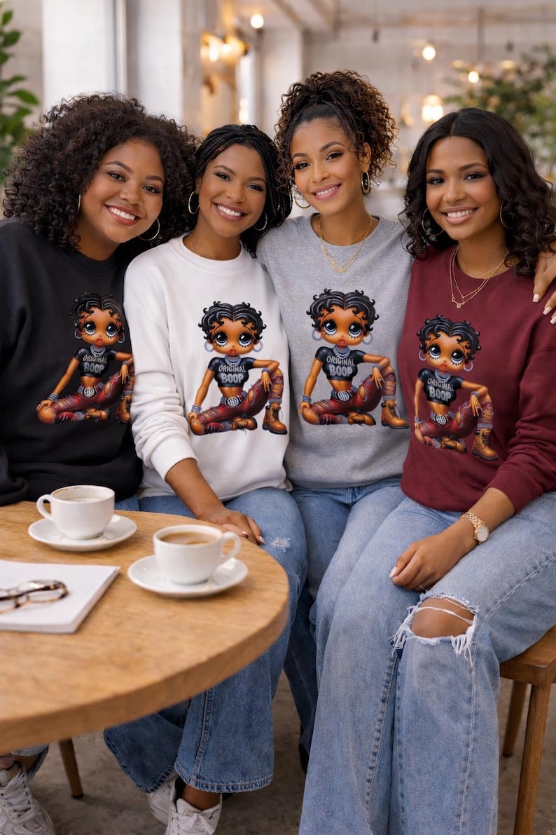 Four people wearing sweatshirts with a Betty Boop cartoon graphic of a woman with the text "Original Boop". The sweatshirts are black, white, gray, and burgundy.
