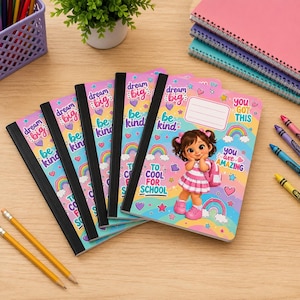 May include: Four identical notebooks with black spines featuring a cartoon girl in a pink dress and backpack. The covers have a light blue background with rainbows, hearts, stars, and text including dream big, be kind, and to cool for school.