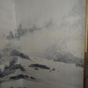 May include: A corner wall mural featuring a landscape scene in shades of gray and white. The artwork depicts a mountainous terrain with trees and water, creating a serene and naturalistic aesthetic. The mural is framed with a gold border.