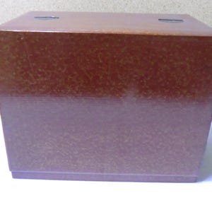 May include: A brown wooden box with a textured surface.