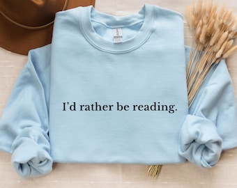May include: A light blue sweatshirt with the text "I'd rather be reading." printed in black.