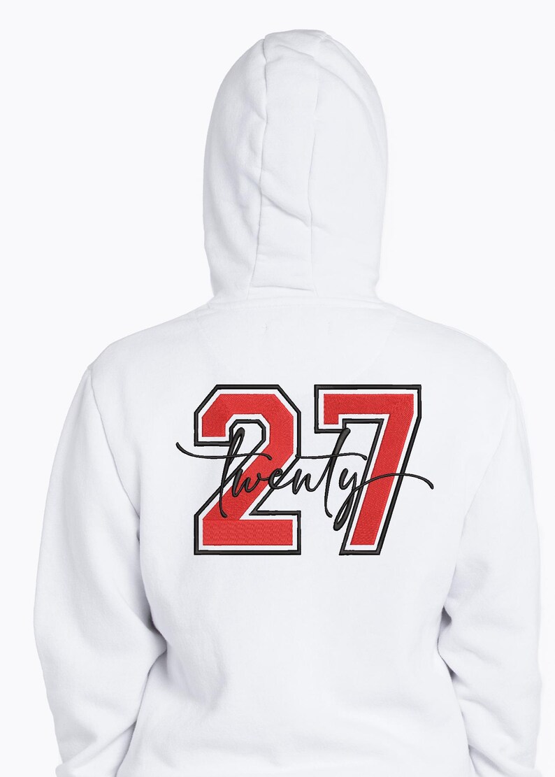 May include: White hooded sweatshirt with the number "27" in red with a black outline. The word "twenty" is written in a cursive font below the number. The sweatshirt is a casual style.