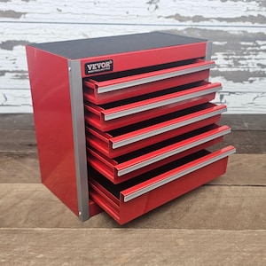 May include: A red metal tool chest with six drawers, each with a silver handle. The top of the chest is black. The brand name "VEVOR" is visible on the front. The chest is designed for tool storage.