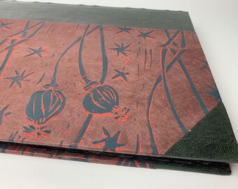 Photo Album with acid-free black pages and poppyseed print, photo album with green leather spine and corners