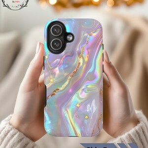 May include: A phone case with a swirling, iridescent marble design in shades of pink, purple, and blue, accented with gold glitter. The case has a camera cutout and the text "Ship Fast". The logo "Sip & Style" is in the upper left corner.
