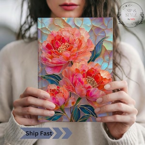 May include: A notebook featuring a vibrant floral design with large, coral-colored peonies. The artwork has a stained-glass effect with gold accents and blue and light blue background. The text "Sip & Style by Sofia" is in the upper right corner.