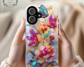 May include: A phone case featuring a floral and butterfly design. The case has a white background with pink, purple, and blue butterflies and flowers. The case has the text "Sip & Style By Sofia" and "Ship Fast".