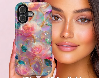 May include: A floral iPhone 17 case with pink roses and iridescent accents. The case has a light blue background and gold detailing. The text "iPhone 17 Available" is displayed on the case. The case is held in a person's hand.