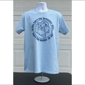 May include: Light blue t-shirt with a blue graphic of a cartoon rabbit. The graphic says "If you can't say somethin' nice... don't say nothin' at all."