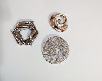 Modernist and Baroque Brooches lot Silver Tone Cherub Circle mark Tara*Swirl Brooch no mark*Abstract Wreath no mark