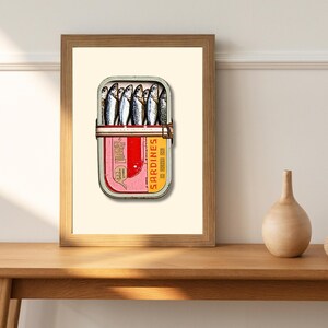 Inside the tin, the sardines are packed snugly, their glossy scales catching the light. Their silvery tones are accentuated with hints of blue and black along the spine, while the soft golden undertones near the fins add warmth.