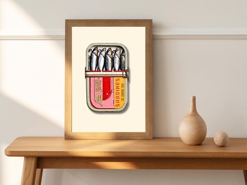 Inside the tin, the sardines are packed snugly, their glossy scales catching the light. Their silvery tones are accentuated with hints of blue and black along the spine, while the soft golden undertones near the fins add warmth.