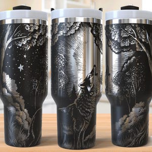 May include: A black stainless steel travel mug with a laser-etched design of a wolf howling at the moon in a forest setting. The mug has a black handle and a white lid.