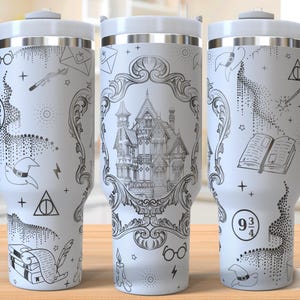 May include: White travel mug with a black and white design featuring a castle, glasses, a wizard hat, and other magical elements. The mug has a white handle and lid.