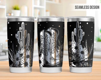 May include: A stainless steel tumbler with a black background and a silver design of cowboy boots, a cactus, and flowers. The design is seamless and wraps around the entire tumbler.