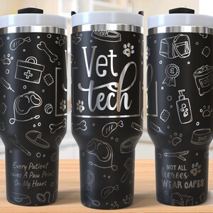 May include: Black stainless steel tumbler with a white lid and handle. The tumbler is decorated with pet-themed illustrations and the words "Vet Tech." Additional text includes "Every Patient leaves A Paw Print On My Heart" and "NOT ALL heroes WEAR CAPES."